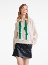 A lady wearing a chic style hoodie.